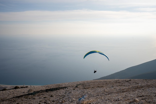 Paraglider is starting Parachute is filling with air in the mountains alps on a sunny day in albania