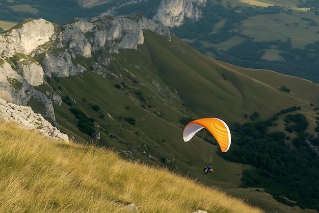 Paraglider Soaring Over Majestic Mountain Landscape