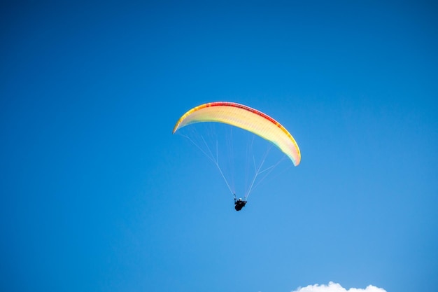 Paragliding flight in the mountains. Le Grand-Bornand, Haute-Savoie, France