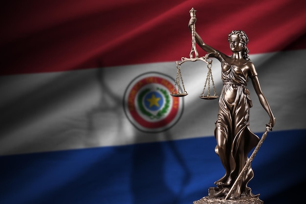 Paraguay flag with statue of lady justice and judicial scales in dark room Concept of judgement and punishment