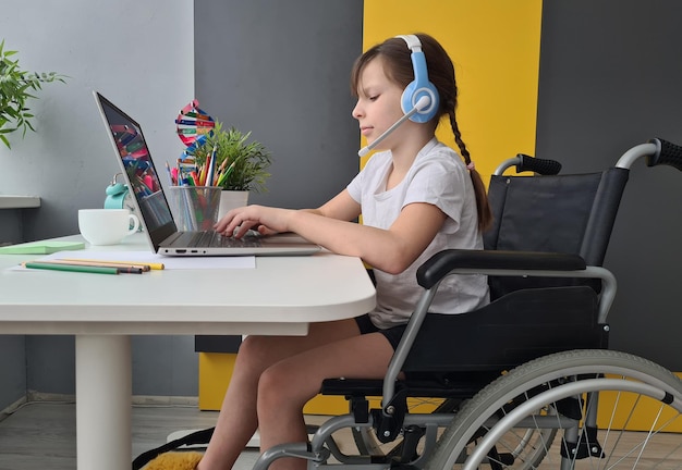 Paralyzed girl in wheelchair on video conference at home