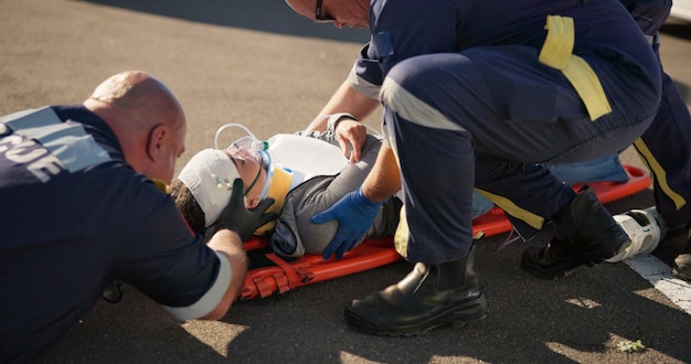 Photo paramedic emergency and injury check on road from car crash accident with healthcare emt men and first aid patient ambulance and medical help with rescue on stretcher for transport to clinic