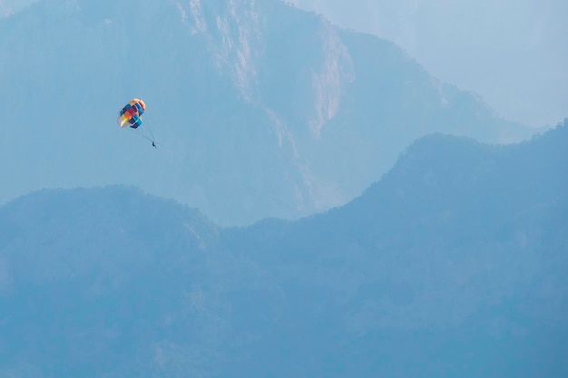 Parasailing over sea on a background of mountains