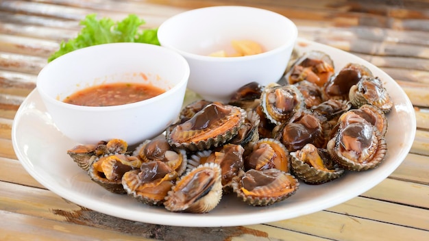 Parboiled cockles or bloody cockles with spicy Thai style dip sauce