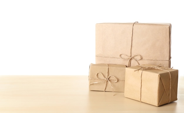 Parcel gift boxes on table against white background