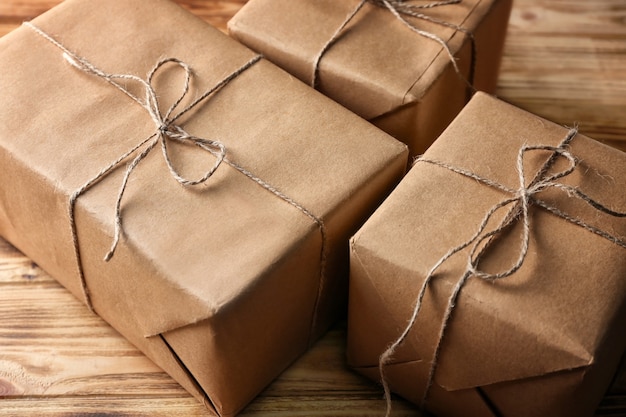 Parcel gift boxes on wooden table, closeup