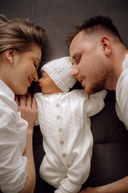 Parent and baby parents and newborn baby on the bed