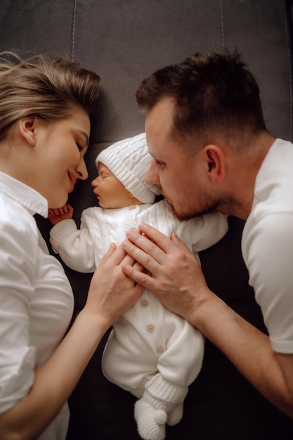 Parent and baby parents and newborn baby on the bed