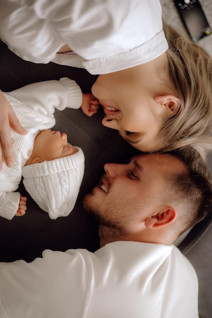 Parent and baby parents and newborn baby on the bed