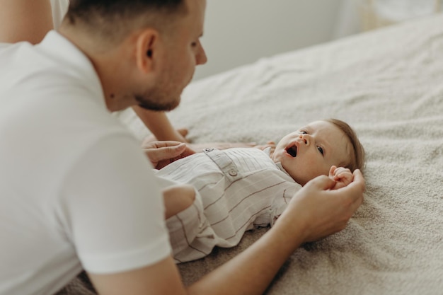 Parent and child father holds the child39s hands little child sleeps in bed