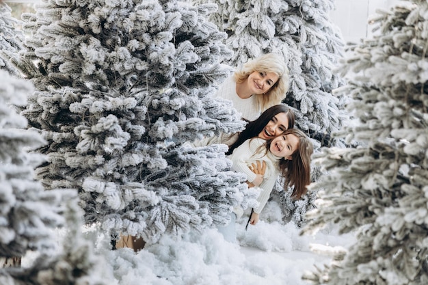 Parent and little child having fun near Christmas tree indoors Loving family with presents in room