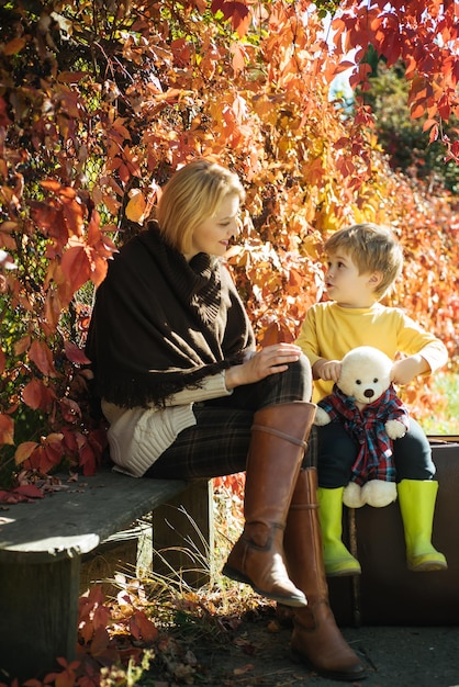 Parenthood and upbringing Boy talking with mom Family conversation Tell mom his secret Mothers day Mom little son communicate autumn foliage background Trustful relations Sincere communication