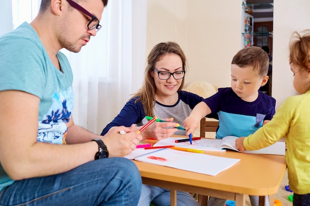 Parents and children draw together in the room