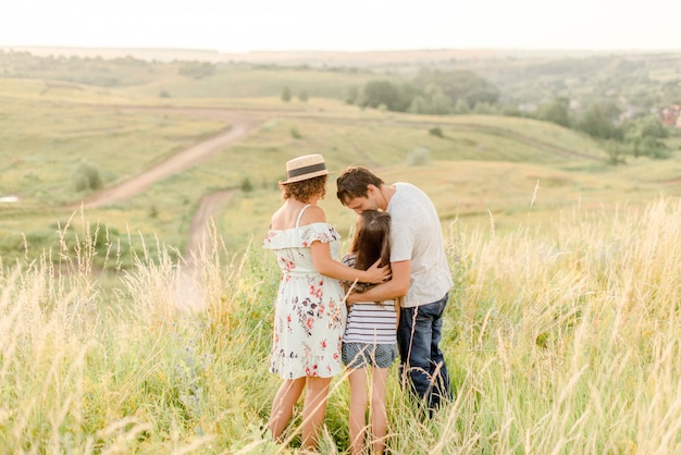 Parents and daughter having rest in a field