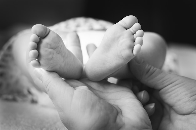 Parents hold in their hands the nights of their newborn daughter, family happiness