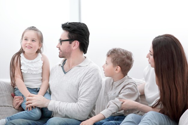 Parents play with children sitting on the couch