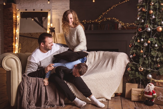 Parents and son near a Christmas tree