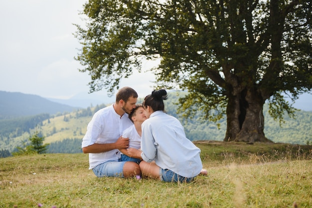 Parents and son relaxing in nature