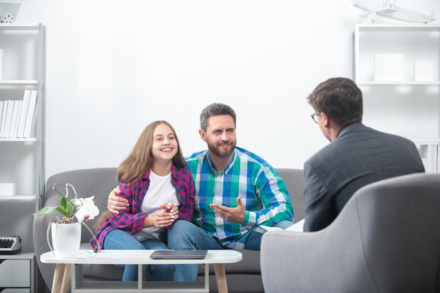 Parents telling the psychologist about family or child problems Family psychologist Psychotherapy with father and and daughter tenager