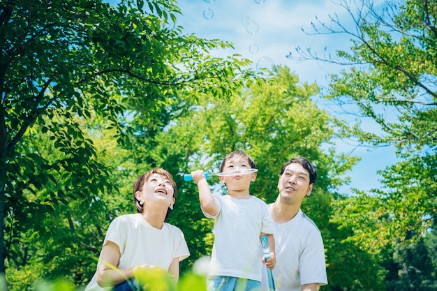 Parents and their child playing with soap bubbles