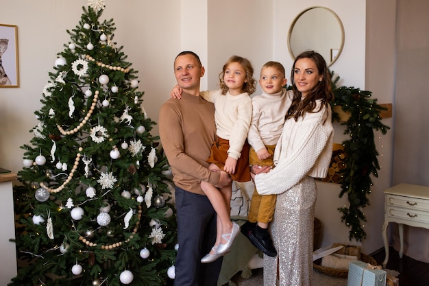 Parents and their cute children having fun indoors on Christmas time