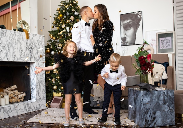 Parents and their happy children daughter and son waiting for Christmas at home Family Christmas at home