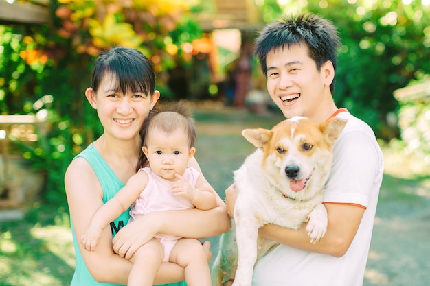 Parents and their little baby girl with a dog