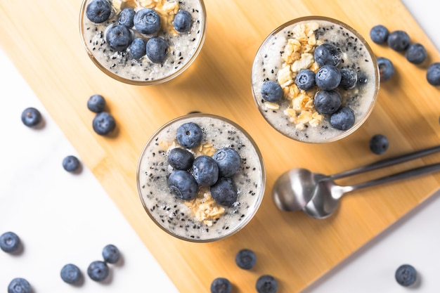 Parfait blueberries with yogurt Healthy breakfast vegetarian vegan food on a light background