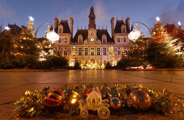 Parisian City Hall decorated with Christmas trees for winter holidays at night