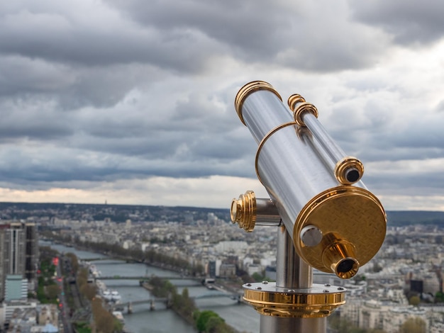 Parisian cityscape with spyglass from Eiffel Tower viewpoint View of Seine River with bridges and Ile aux Cygnes