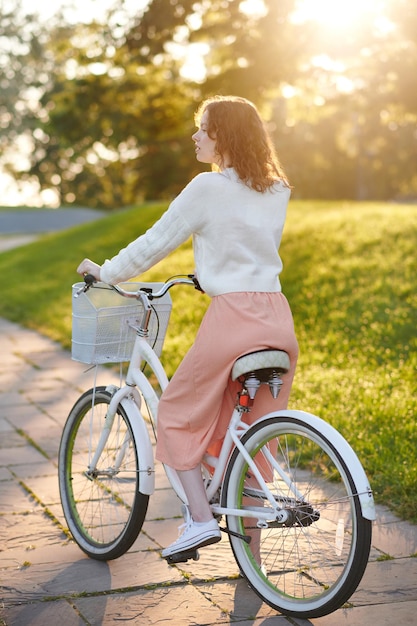 In the park. Young girl with a bike in the park