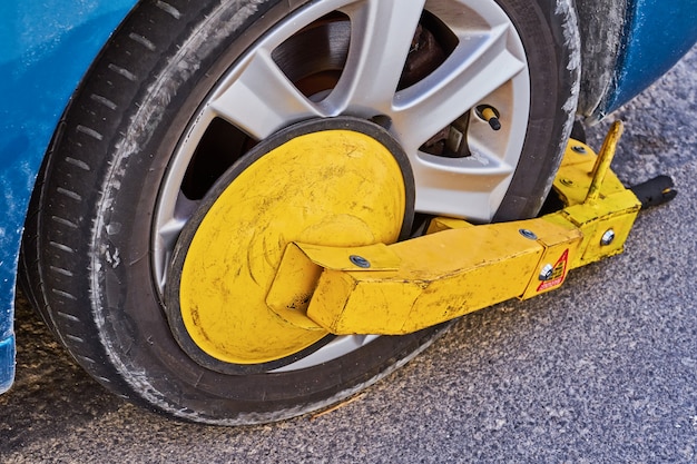 Parked car with an immobilizer tire lock of illegally