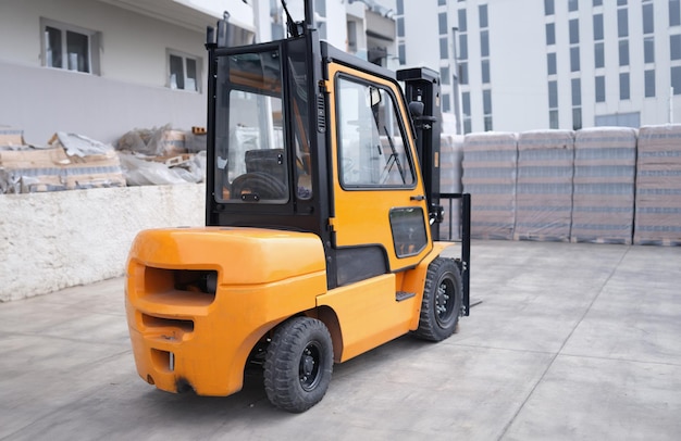 Parking forklift in logistics warehouse Pallet stacking equipment outside and modern warehouse storage concept