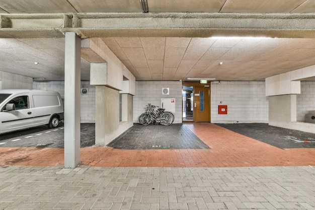 A parking garage with bikes and a van in it