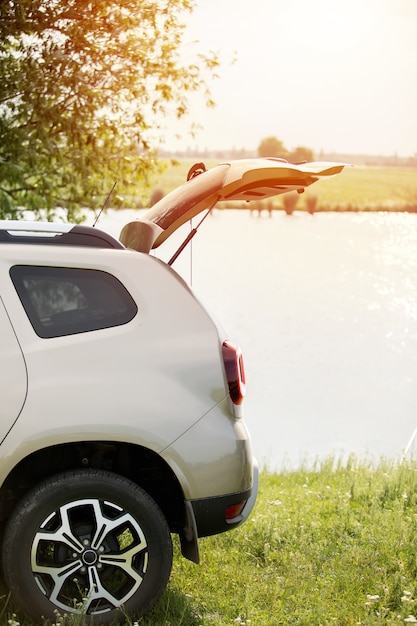 Part of the car with an open trunk in nature.