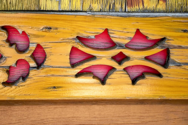 Part of carved pattern on wooden plank