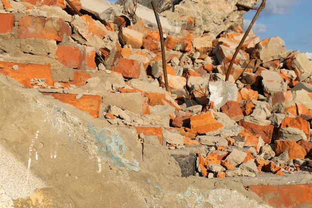 Part of the destroyed brick wall against a cloudy sky The concept of housing loss