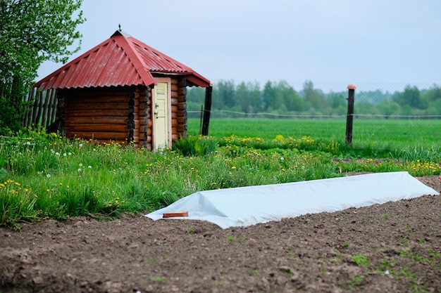 Part of the ground is covered with a film for plants from the cold