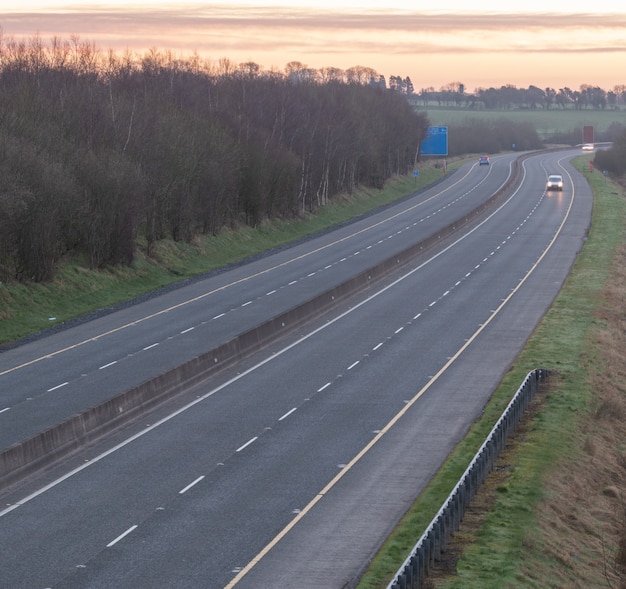 Part of a motorway from Dublin to Galway at sunrise .