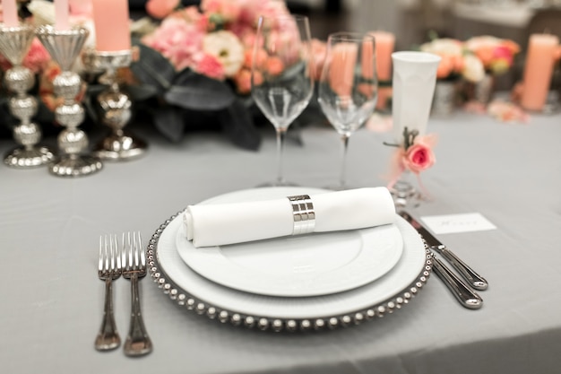 Part of stylish table setting with plate and cutlery. 