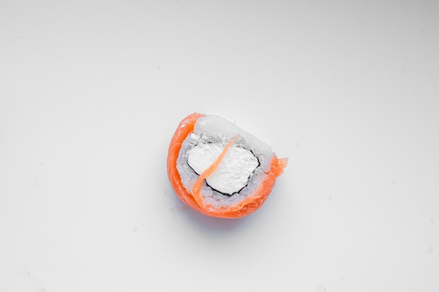 Part of a sushi roll on a wooden background Philadelphia cheese