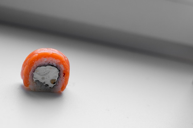 Part of a sushi roll on a wooden background Philadelphia cheese