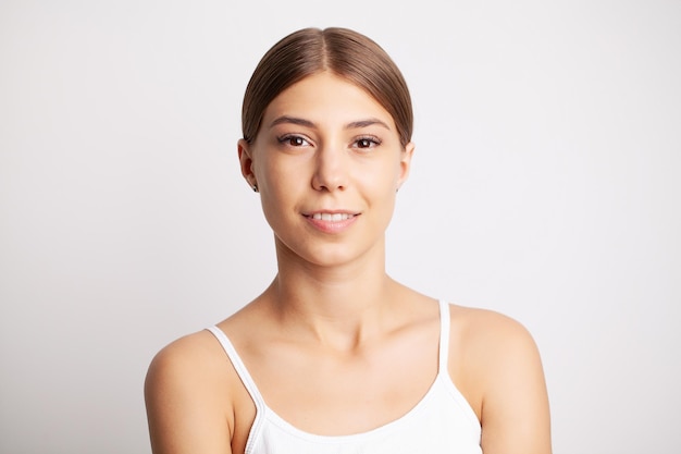 Partial portrait of girl with strong white teeth looking at camera and smiling