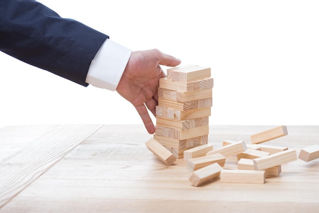 Partial view of businessman playing blocks wood game isolated on white