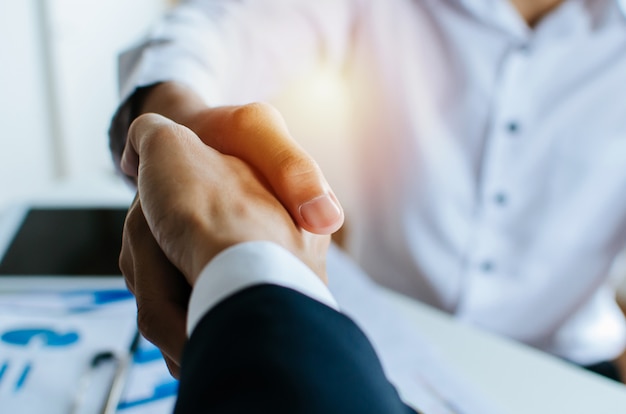 Partnership. two business people shaking hand after business job interview in meeting room at office