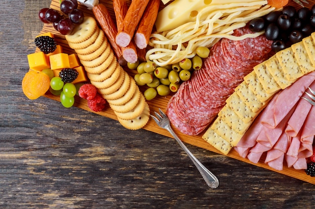 Party appetizer plate consisting of cheese, crackers, nuts, and other party snacks.