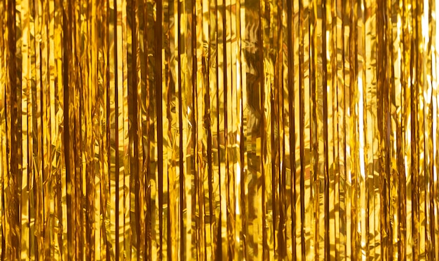 Party Background. Decor made of gold foil, tinsel and candy.