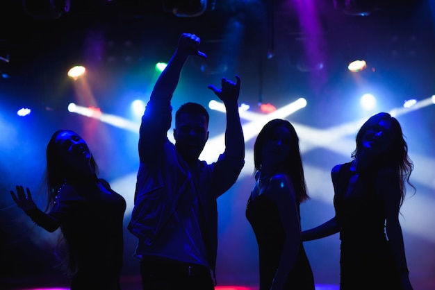 Party, holidays, celebration, nightlife and people concept - group of happy friends dancing in night club