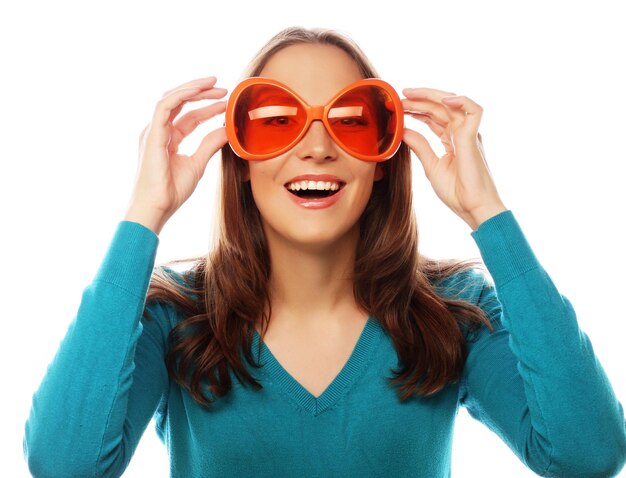 Party image Playful young woman with big party glasses Ready for good time