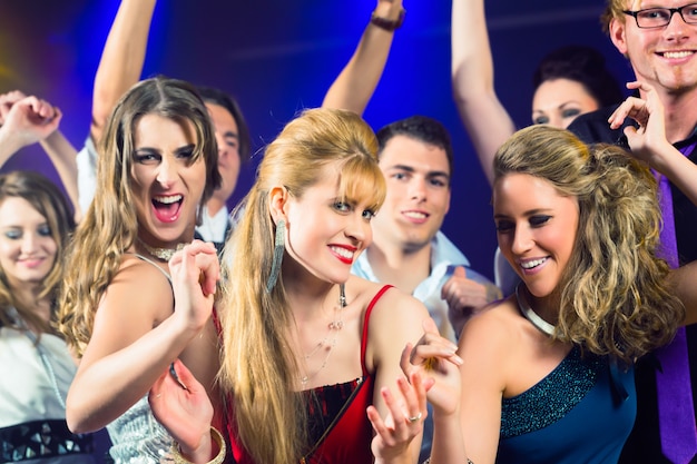 Party people dancing in disco club